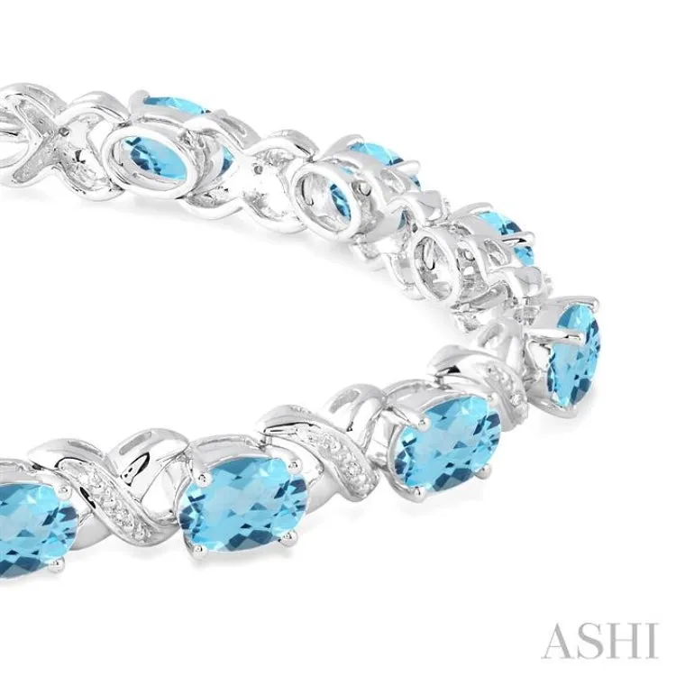 7x5  MM Oval Cut Blue Topaz and 1/20 ctw Round Cut Diamond Fashion Bracelet in Sterling Silver