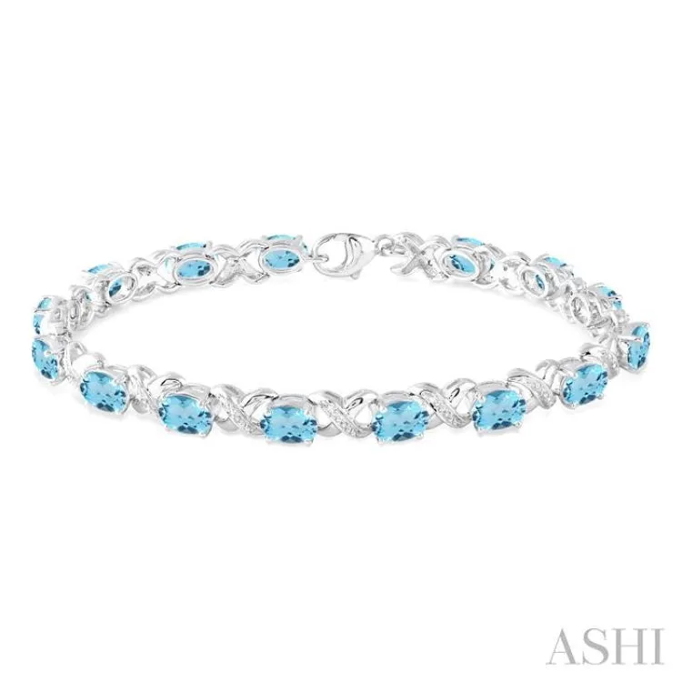 7x5  MM Oval Cut Blue Topaz and 1/20 ctw Round Cut Diamond Fashion Bracelet in Sterling Silver